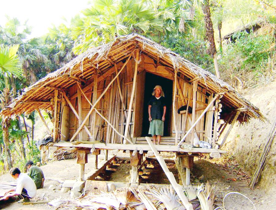 Honglin Khiamniungan (65) is seen here standing at the door of her granary in Tuensang, whose thatch roof was built with the help of other villagers.